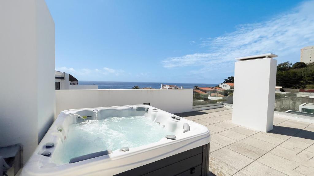 a bath tub sitting on top of a balcony at Oceanside East in Ponta Delgada