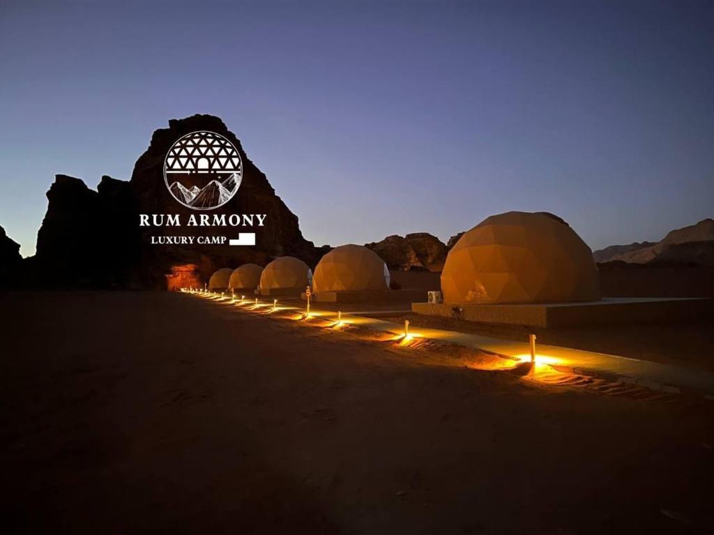 a row of tents in the desert at night at Rum Armony camp in Wadi Rum