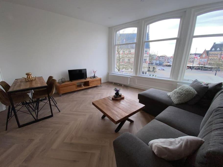 a living room with a couch and a table at Apartement City Center Gouda: View Deluxe in Gouda