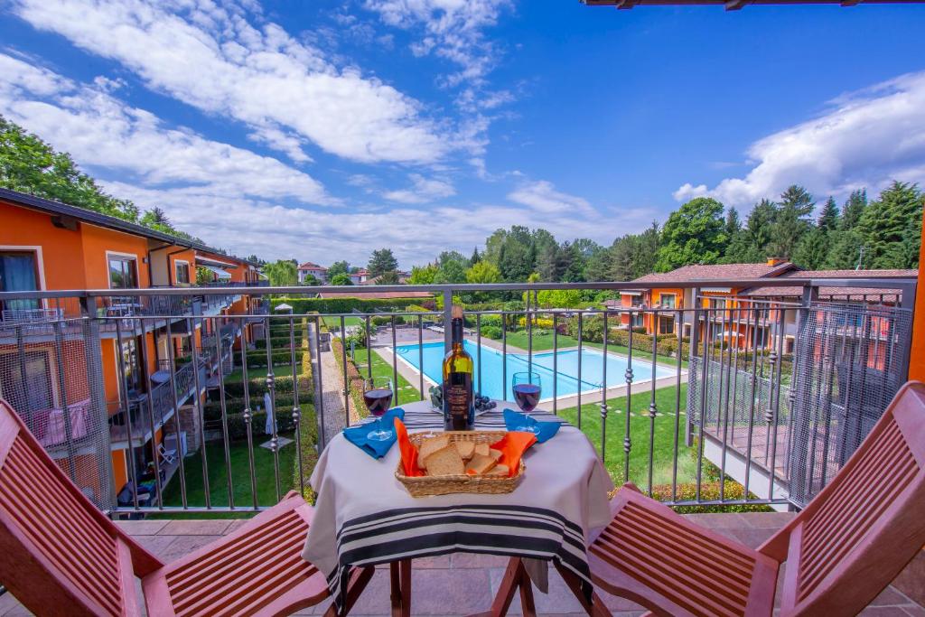 una vista sulla piscina dal balcone di una casa di Relax al Moro Apt with Pool a Reno Di Leggiuno