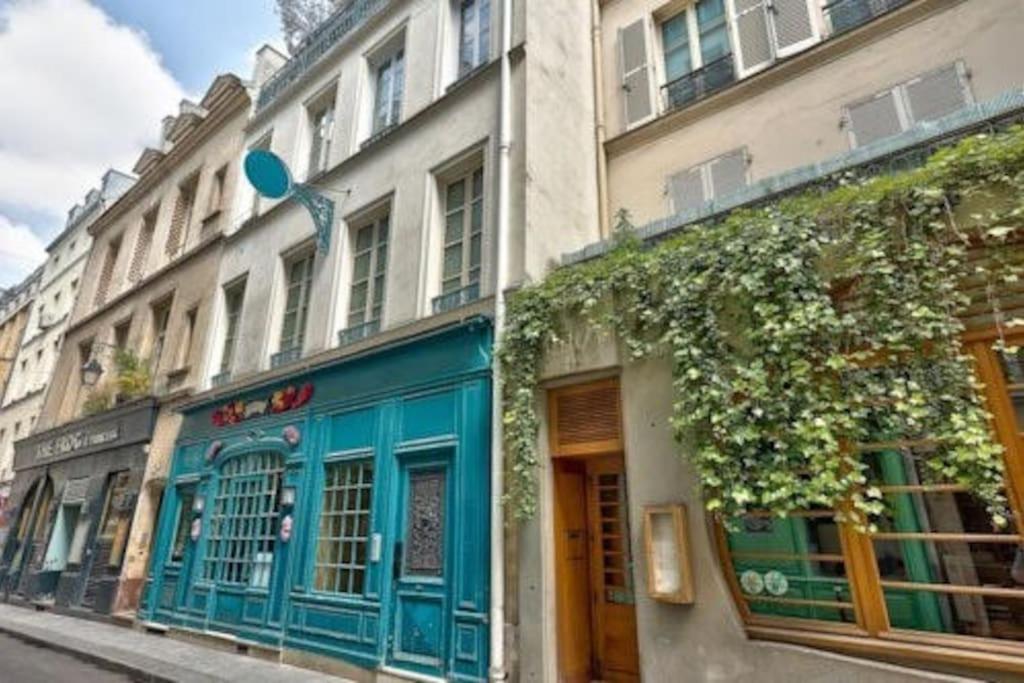 a building with blue paint on the side of a street at Cozy 1BR in the Heart Of Paris in Paris