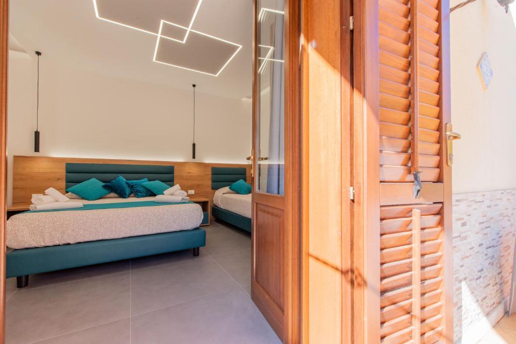 a small bedroom with a bed and a window at Room & Breakfast Aloe in San Vito lo Capo