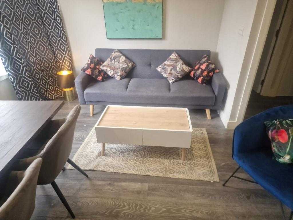 a living room with a couch and a coffee table at Richmond Apartments in London