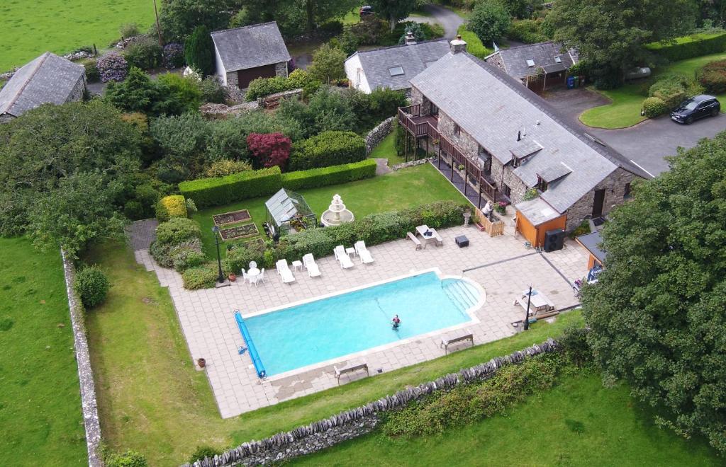 an aerial view of a house with a swimming pool at The Old Farmhouse B&B in Dyffryn