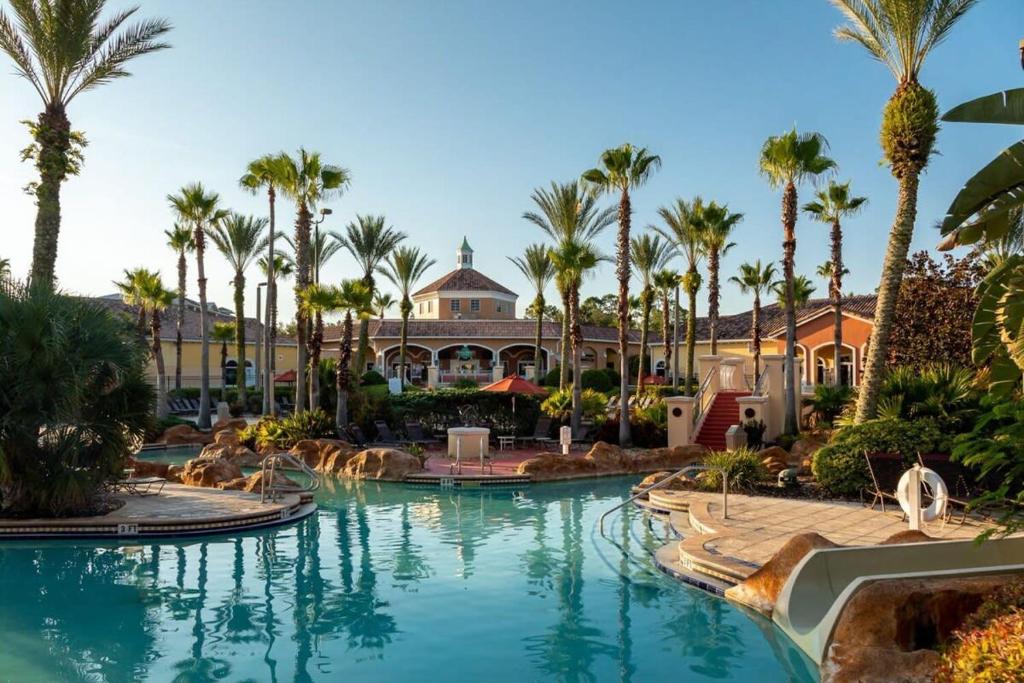 a resort with palm trees and a swimming pool at Resort w Lazy River and Arcade 30mis to Disney in Davenport