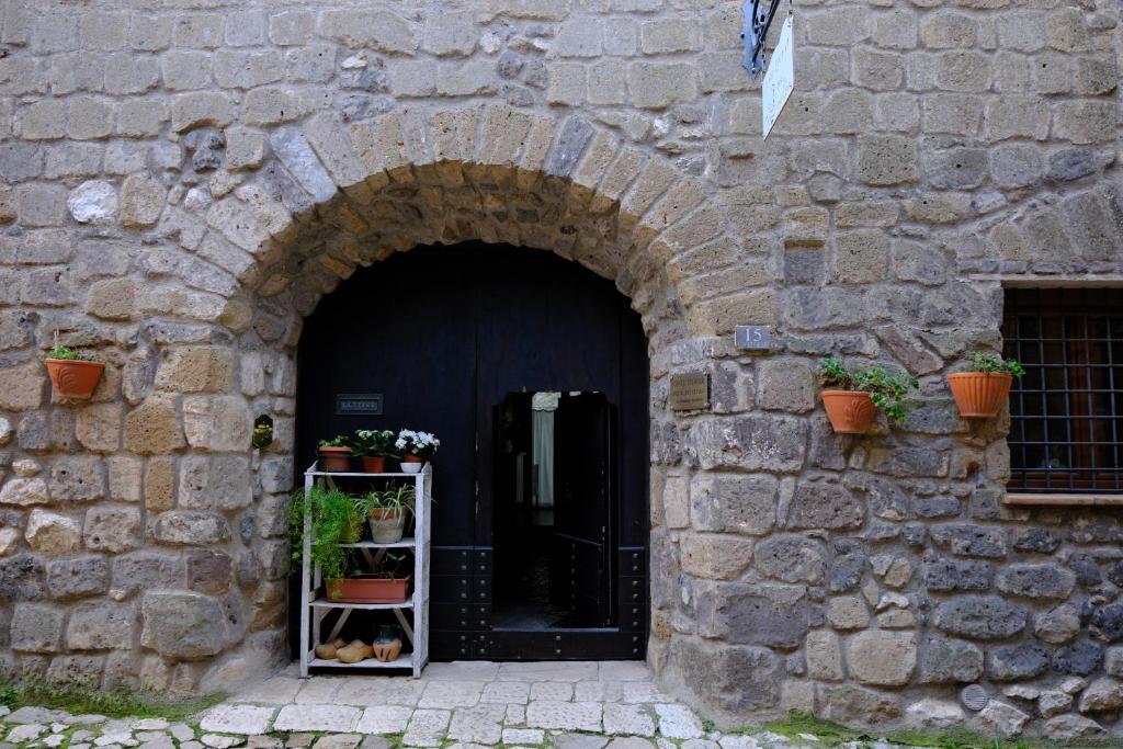 an entrance to a stone building with a black door at Conte Spencer in Casertavecchia