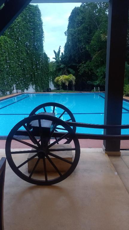 a woodenoked wheel sitting in front of a pool at THE Mangrove cave Hotel in Balapitiya