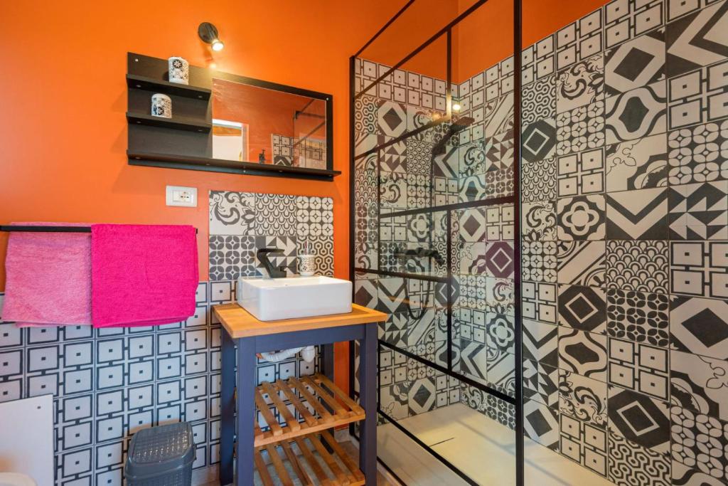 une salle de bain avec un mur orange et un lavabo dans l'établissement Villa Maguetta with private pool in Scopello, à Scopello