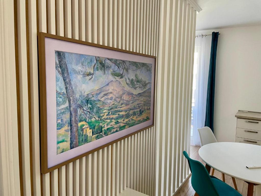 a painting hanging on a wall in a room at ART Apartment III in Târgu-Mureş