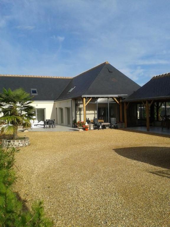 a house with a gravel yard in front of it at Maison Chauvin in Château-du-Loir