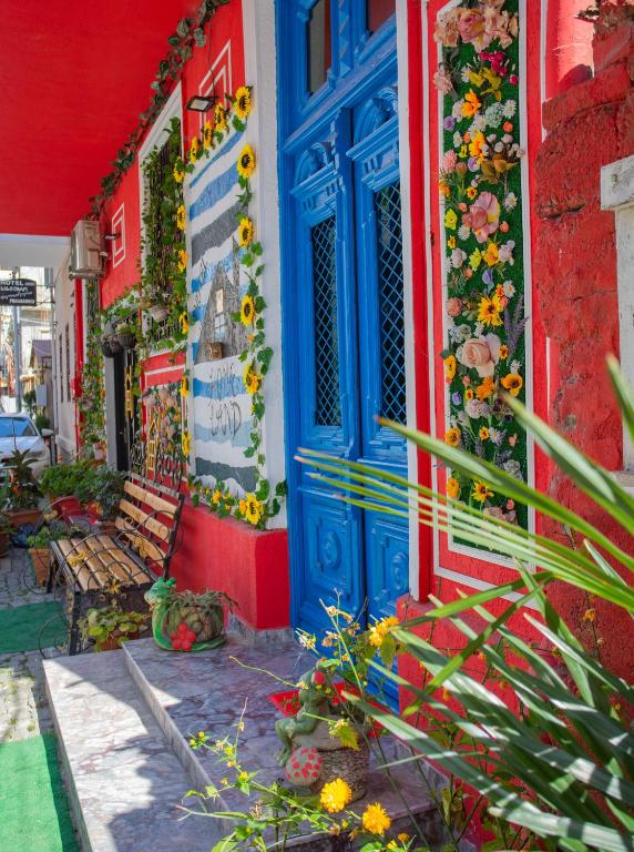 a blue door on a building with flowers on it at Hotel Homeland in Batumi