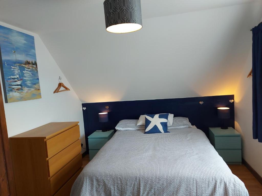 a bedroom with a bed with a blue headboard at Chezzas in Poole