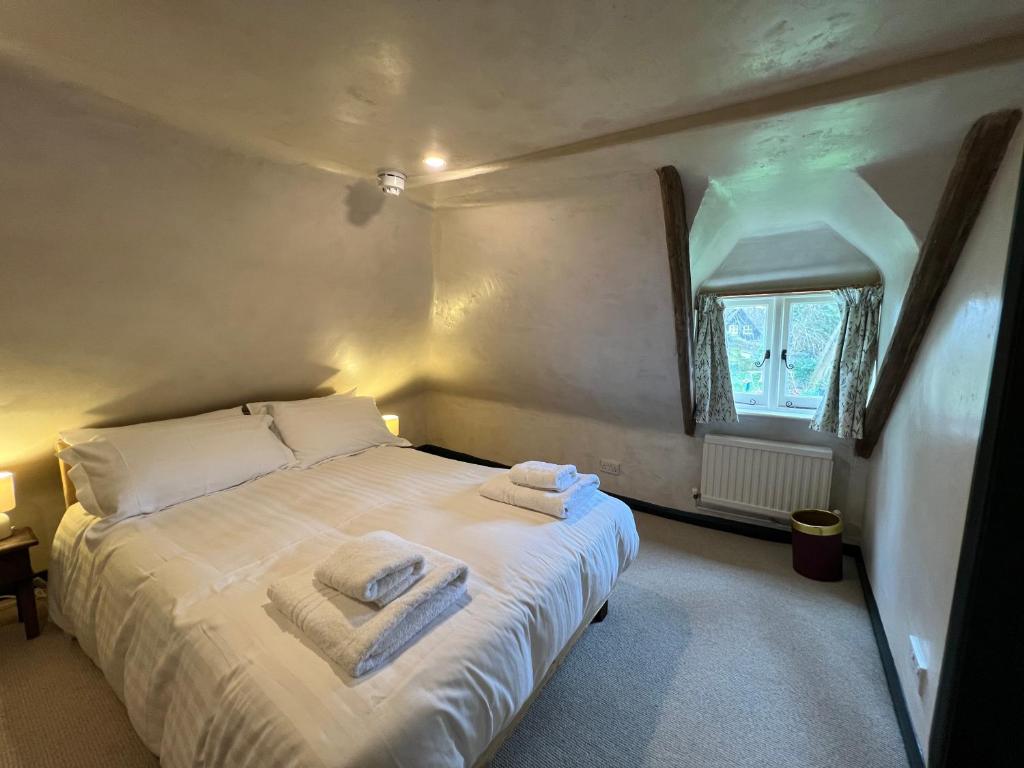 a bedroom with a bed with towels on it at Strand House in Winchelsea