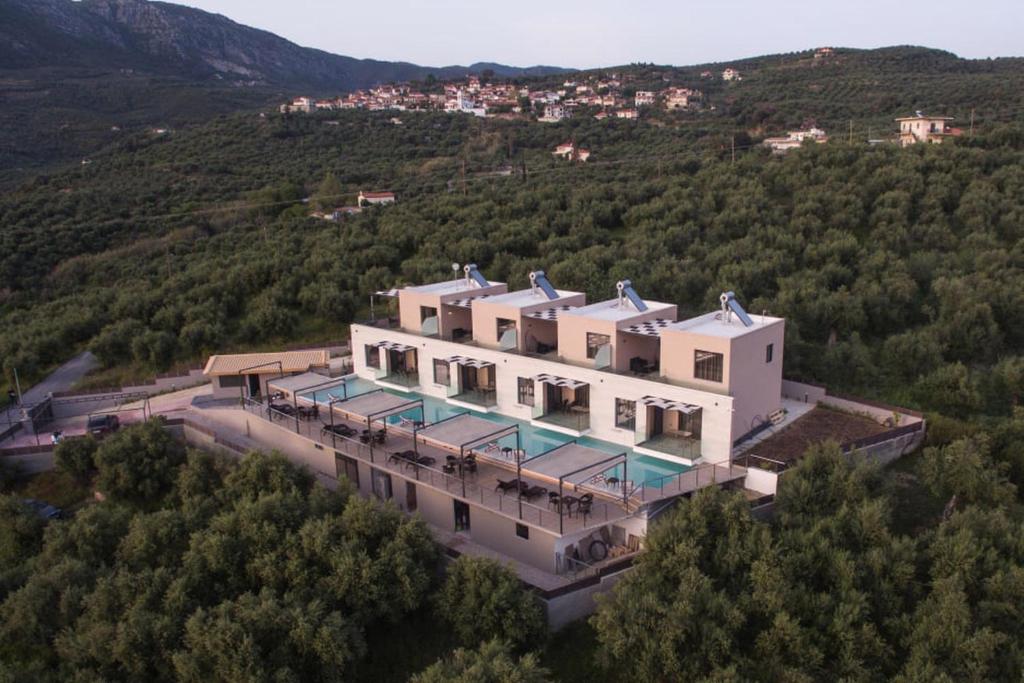 an aerial view of a large house in the mountains at Serenity Suites Sea View Houses - Happy Rentals in Káto Xirokhórion