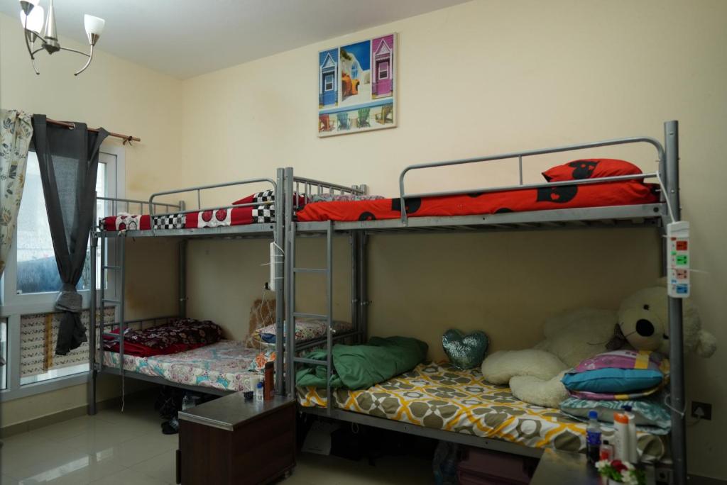 a bedroom with two bunk beds and a window at Women Only Hostel near Burjuman Metro exit 4 in Dubai