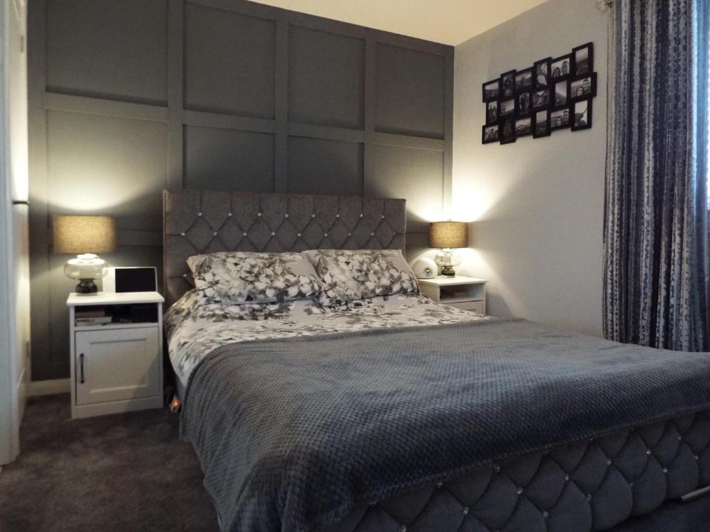 a bedroom with a large bed and two night stands at Modern 2 Bed in Troon in Loans