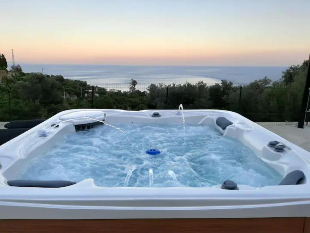 a jacuzzi tub with a view of the ocean at Casal Trinacria in Santa Teresa di Riva