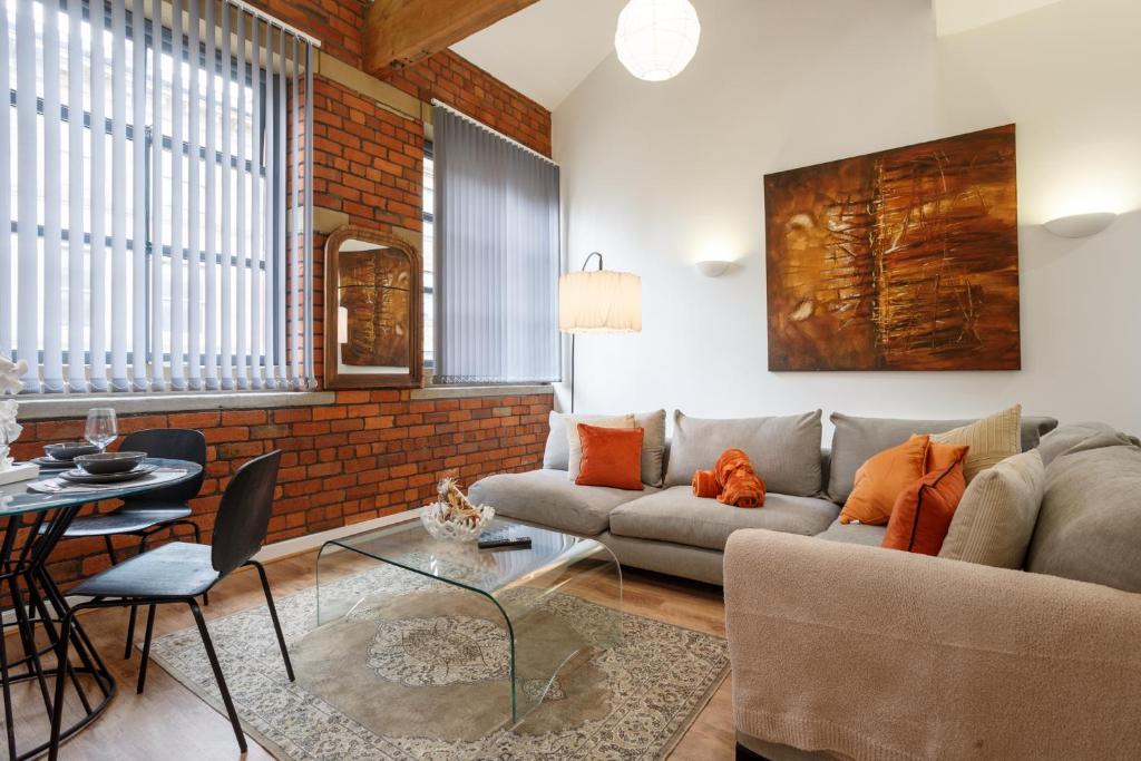 a living room with a couch and a table at Cozy Downtown Loft in Bradford in Bradford