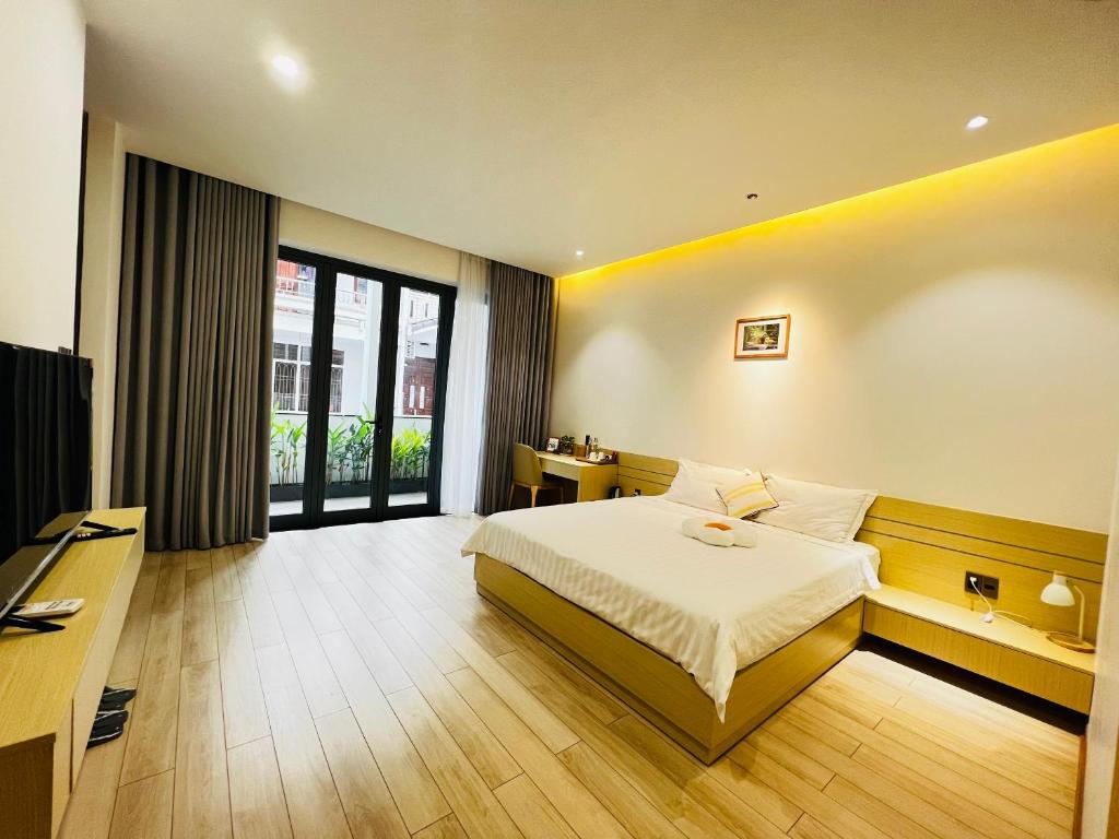 a hotel room with a bed and a desk at Bibi’s home in Danang