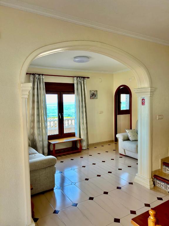 a living room with a couch and a table at Casa CaboMar in Torrevieja