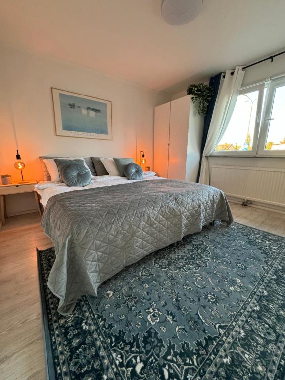 a bedroom with a large bed and a rug at Central Peaceful Villa, Malmö in Malmö