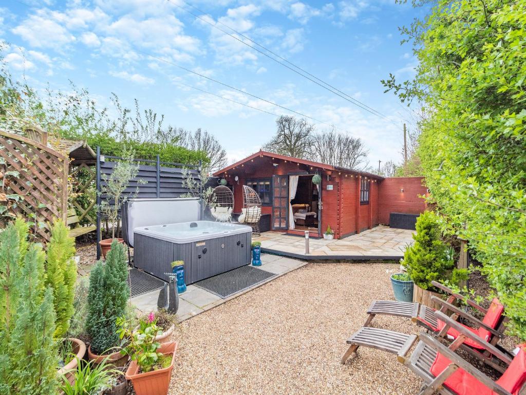 a backyard with a hot tub in a garden at Easthorpe Retreat in Copford