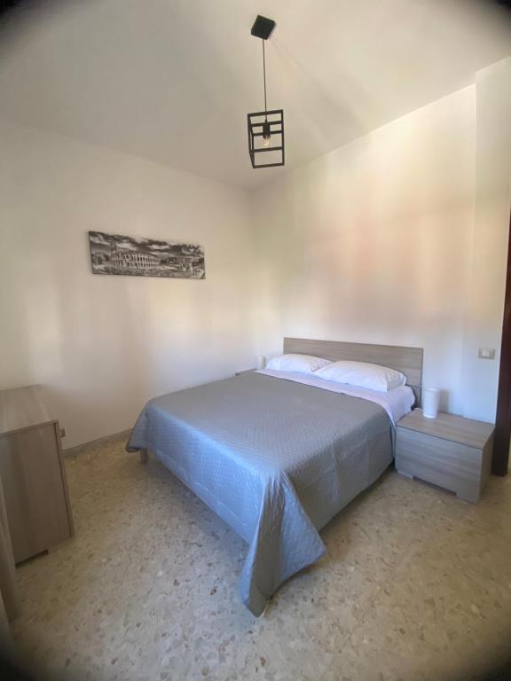 a bedroom with a large bed and a light at Reversal apartment in Santa Marinella