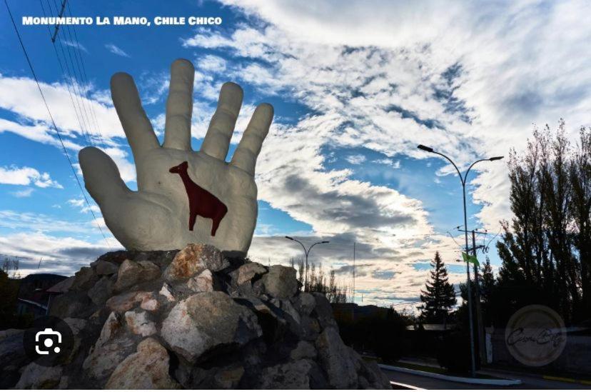 a statue of a hand on a pile of rocks at Cabaña Duvi-du in Chile Chico