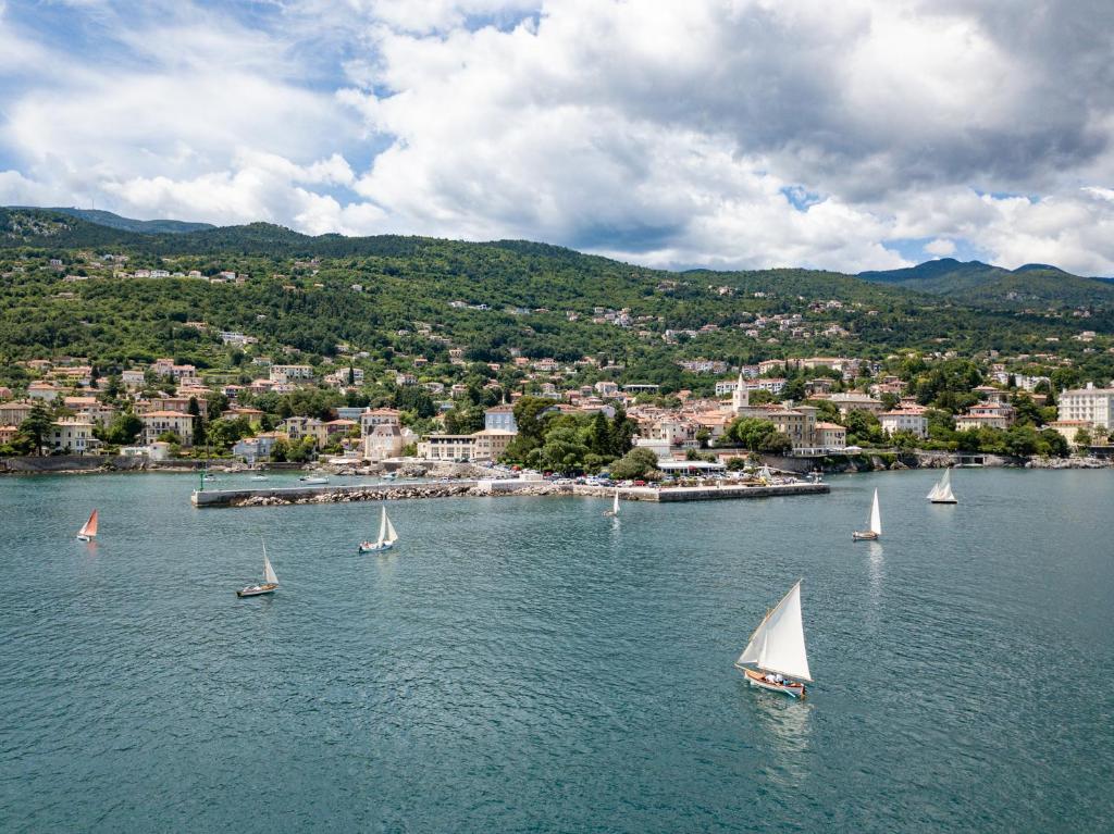 a group of sailboats in a large body of water at Apartman Kesten in Lovran
