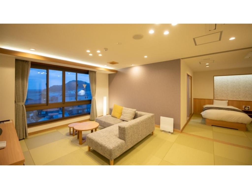 a living room with a couch and a bed at KAISYU - Vacation STAY 42715v in Kyotango