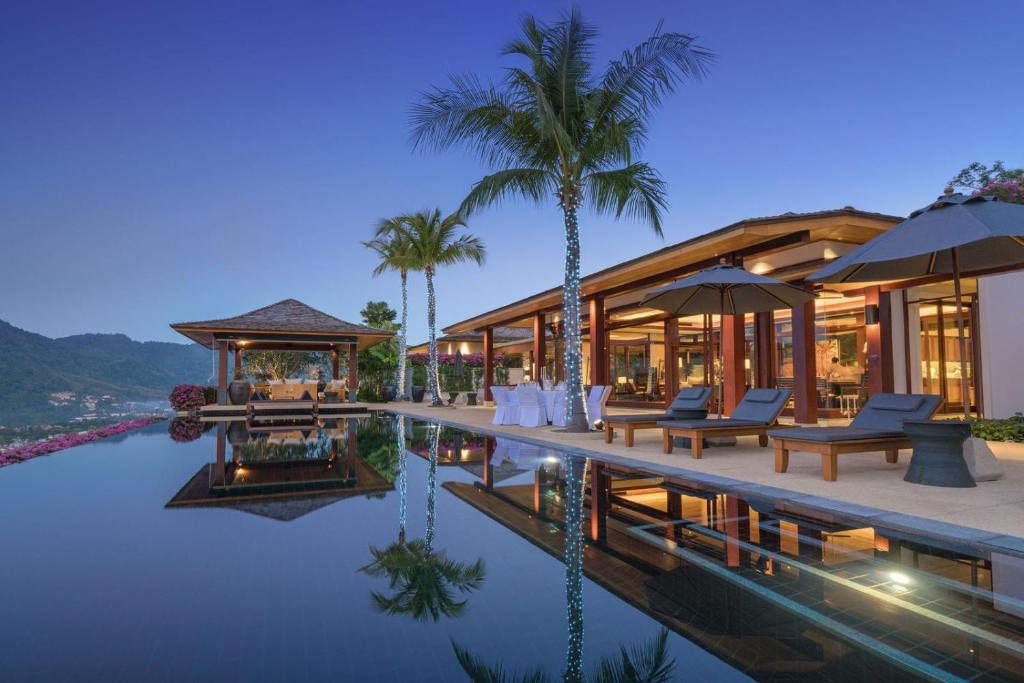 a resort with a swimming pool and palm trees at Villa 29 Montebello Andara Resort Villas in Kamala Beach