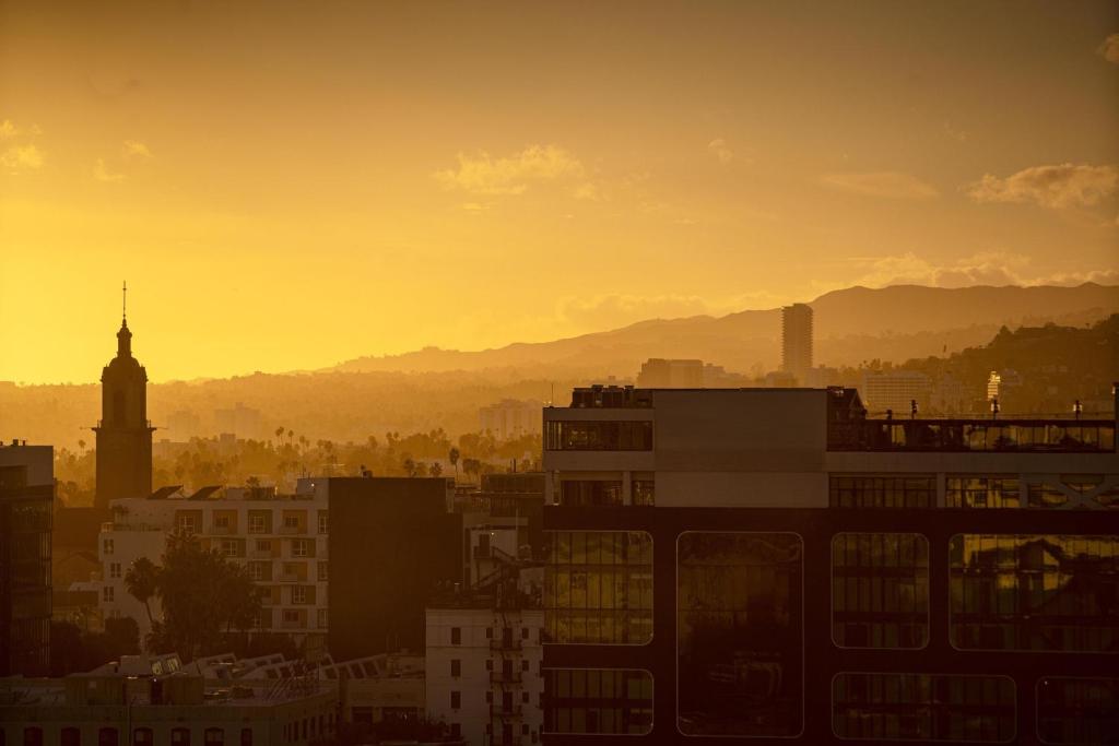 a city skyline at sunset with a clock tower at W Hollywood in Los Angeles