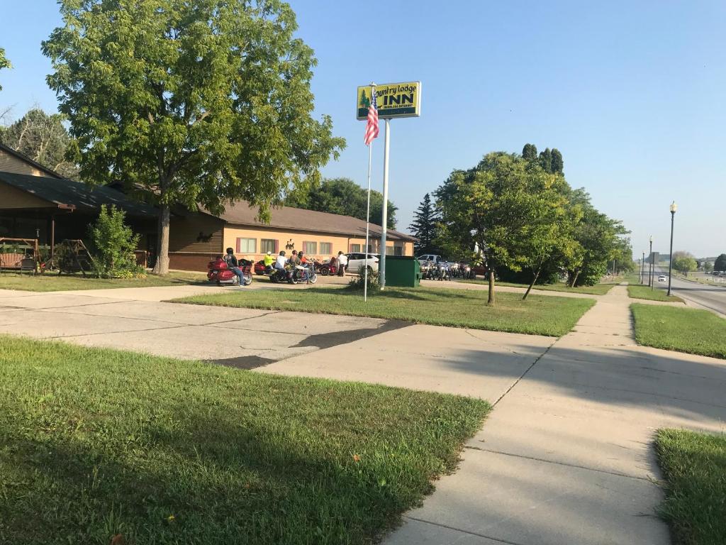 a building with an american flag on a street at Country Lodge Inn in Florenceville