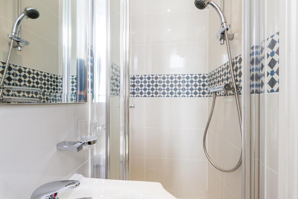 a bathroom with a shower and a sink at Gower Hotel in London