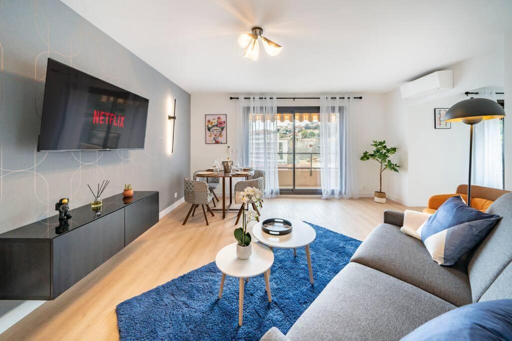 a living room with a couch and a tv at Monte Carlo Monaco Border, Swimming Pool, Parking, See View, Terrace in Beausoleil