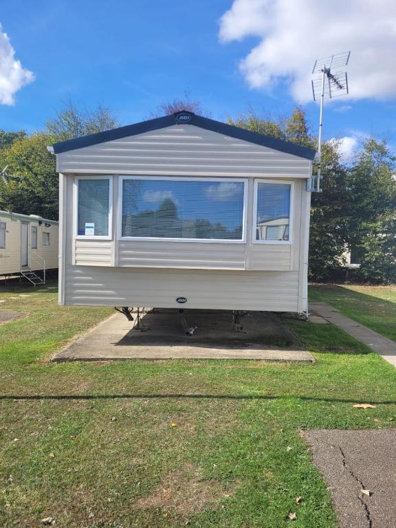 a tiny house is parked in a yard at Highfield Grange Holiday Park in Little Clacton