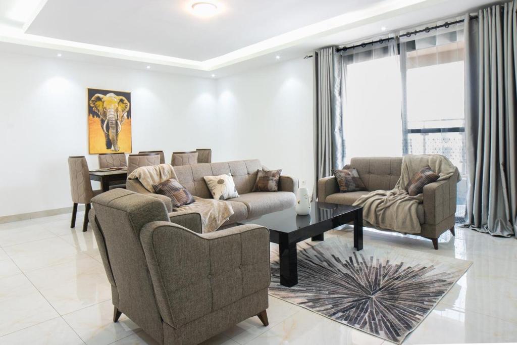 a living room with two couches and a table at Residence Mandela Almadies Dakar, Senegal, Ngor Almadies in Ngor