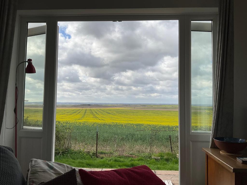 a view of a field from a window at Shirls chalet in Sheppey, Leysdown in Leysdown-on-Sea