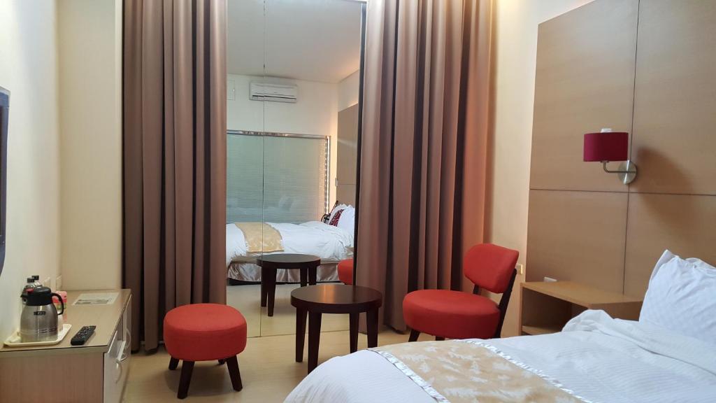 a hotel room with two beds and a mirror at Yang Home Stay in Ruisui