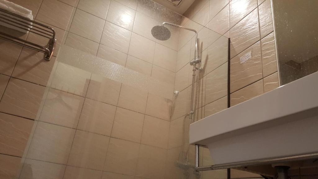 a bathroom with a shower with a glass door at Yang Home Stay in Ruisui