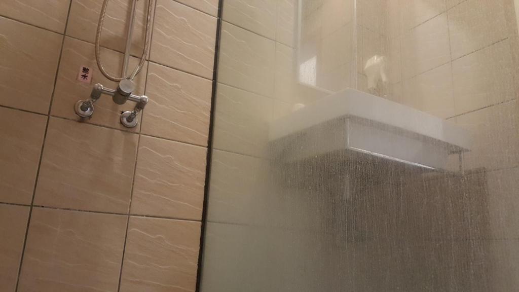 a shower in a bathroom with a shower curtain at Yang Home Stay in Ruisui