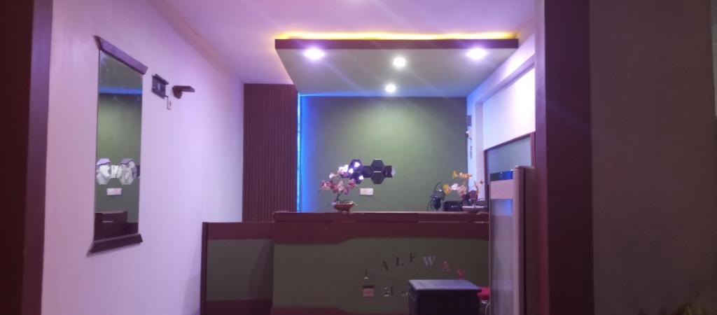 a bathroom with a large mirror and a sink at New KAMI Homestay in Banyuwangi