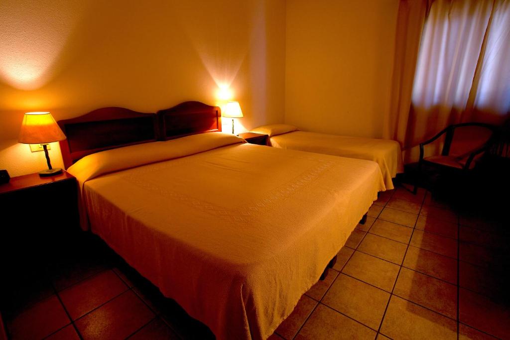 Postel nebo postele na pokoji v ubytování Hotel Moderno