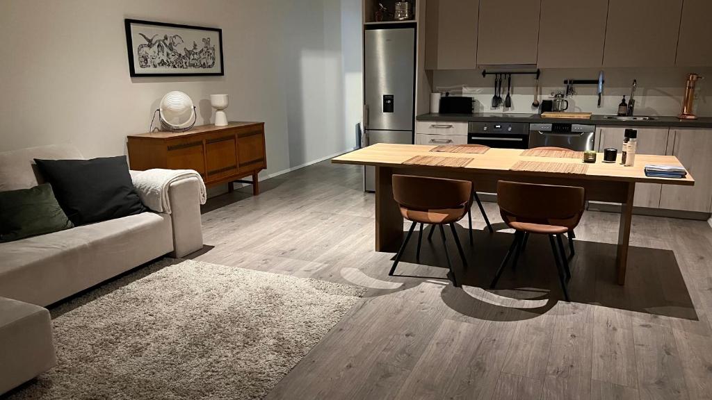 a kitchen with a table and chairs in a room at Modern luxury apt downtown in Reykjavík