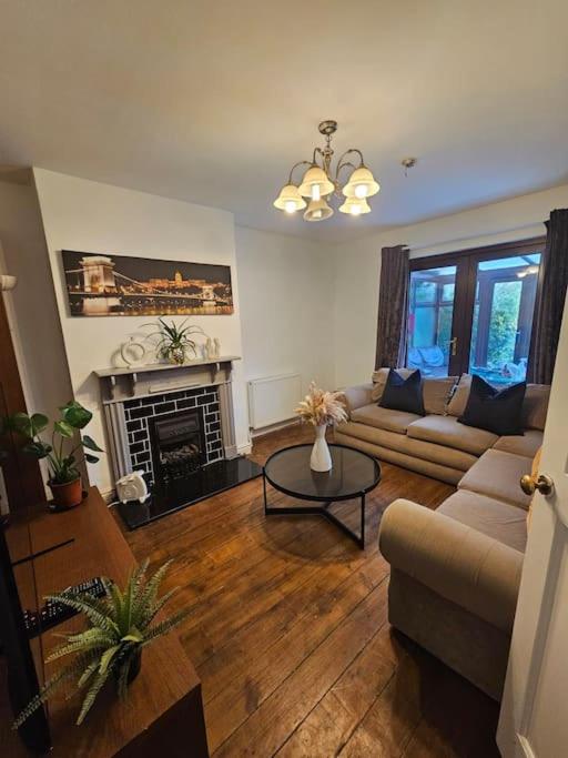 a living room with a couch and a fireplace at Quiet family home in Tettenhall
