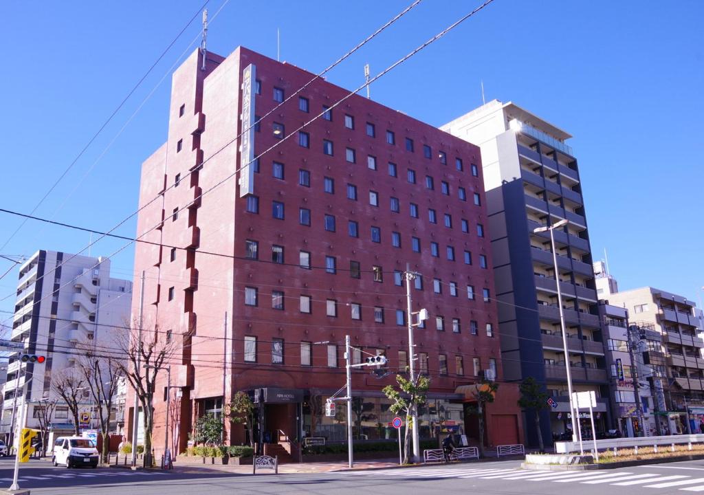 un gran edificio de ladrillo rojo en una calle de la ciudad en APA Hotel Tokyo Kiba en Tokio