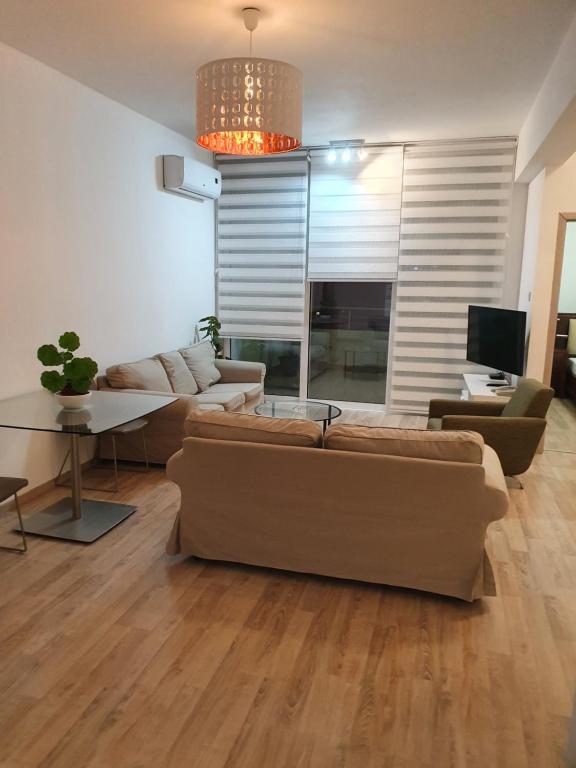 a living room with a couch and a table at Elegance in Nicosia