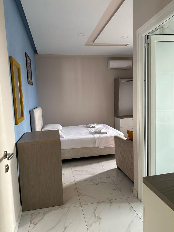 a bedroom with a bed and a tv in it at Summer Gate Hotel in Ksamil