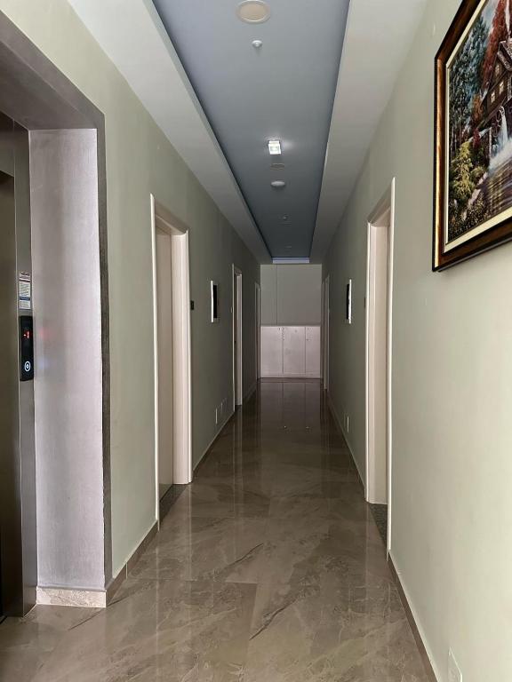 a hallway of an office building with a painting on the wall at Summer Gate Hotel in Ksamil