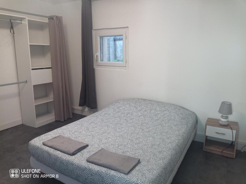 a bedroom with a bed and a window at Etablissements Coulon Saint-Joseph en face de Bagatelle in Talence